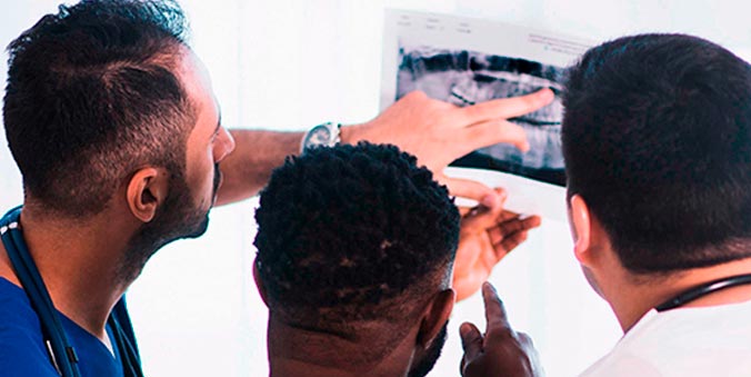 Dentist analyzing an oral x-ray